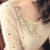 莎莱 韩版可爱圆点针织衫时尚亮片娃娃领毛衣XY09314(米白色)第5张高清大图